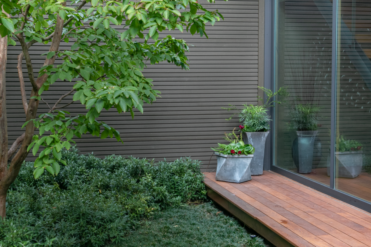 Stylish zinc containers in a modern courtyard garden