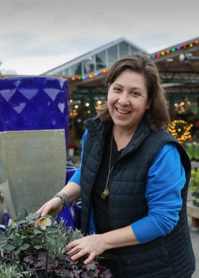 Grace styling plants in a container